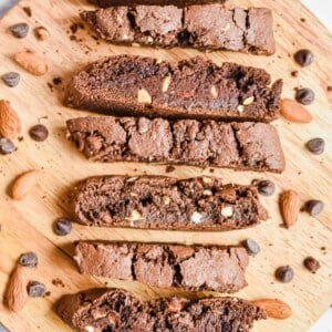 An overhead shot of the chocolate biscotti on a circular cutting board