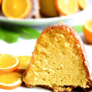 A close up of a slice of orange bundt cake