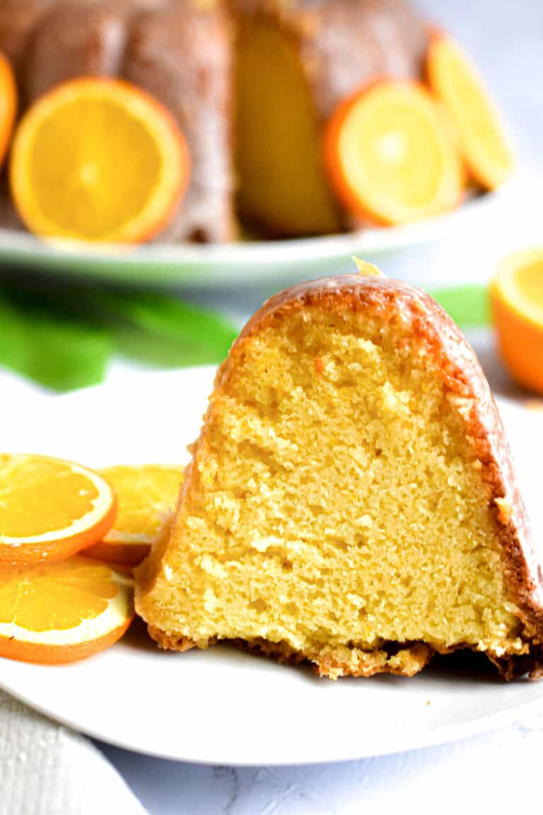 A close up of a slice of orange bundt cake