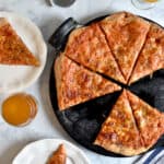 An overhead view of the sourdough pizza dough with two slices around it
