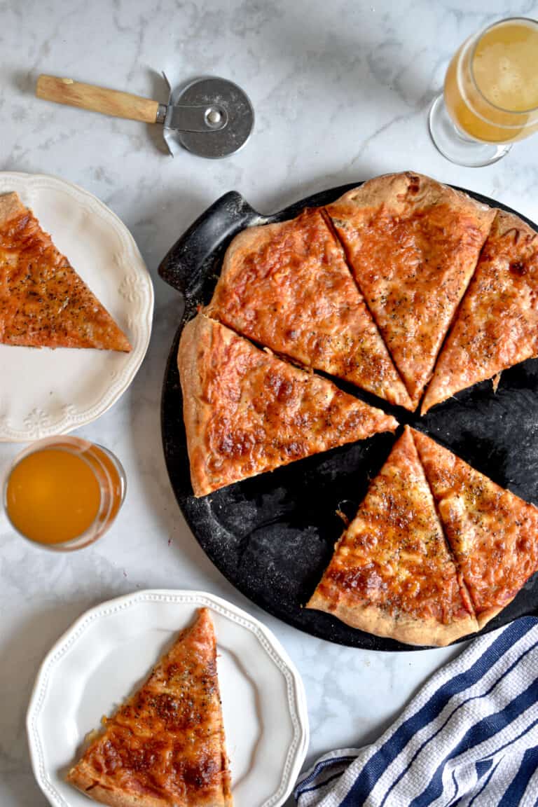 An overhead view of the sourdough pizza dough with two slices around it