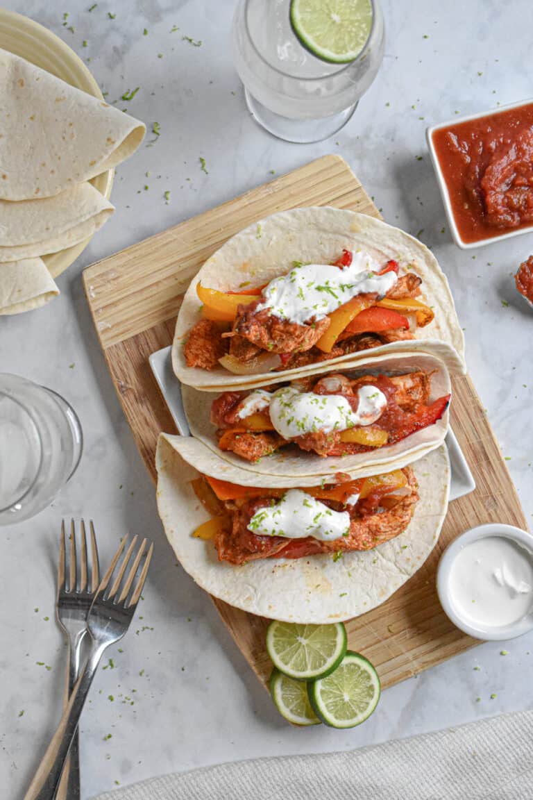 Easy Sheet Pan Chicken Fajitas served with sour cream and salsa