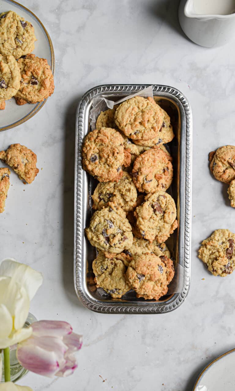 Cookies laid out on a plate with tulips on the edge of the frame