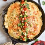 Top the salsa verde chicken bake with avocado and tomatoes