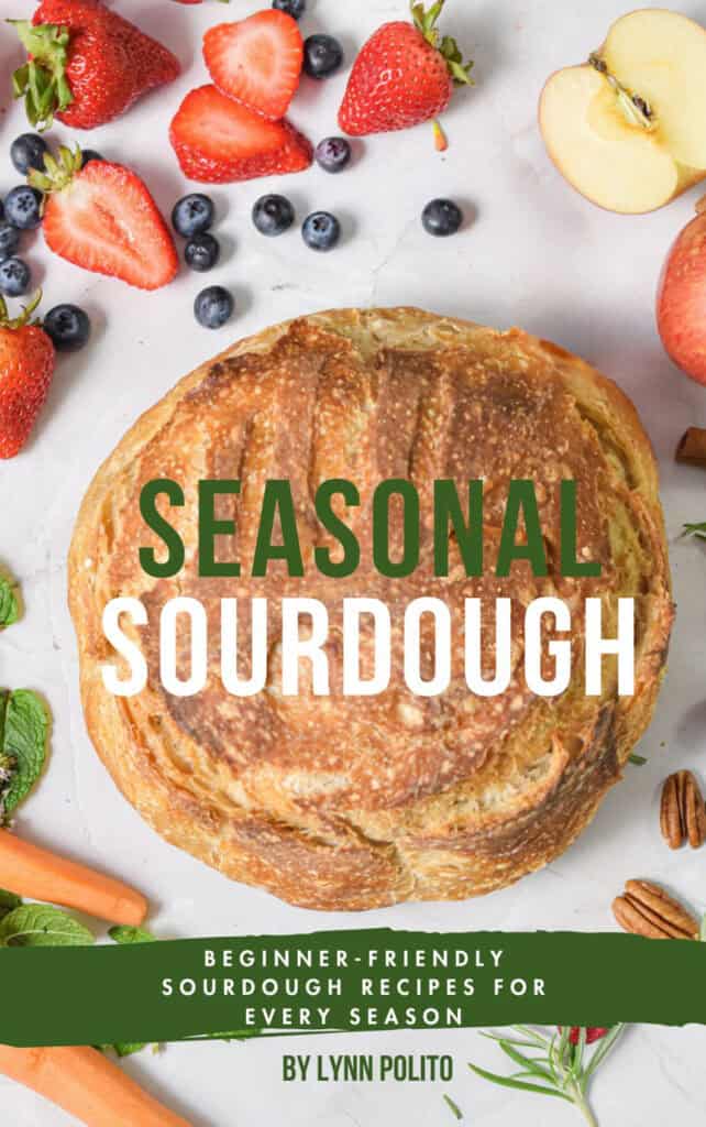 Seasonal sourdough cookbook is shown with a loaf of bread surrounded by fruit.