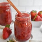 3 Ingredient Instant Pot Strawberry jam with a wooden spoon in the mason jar