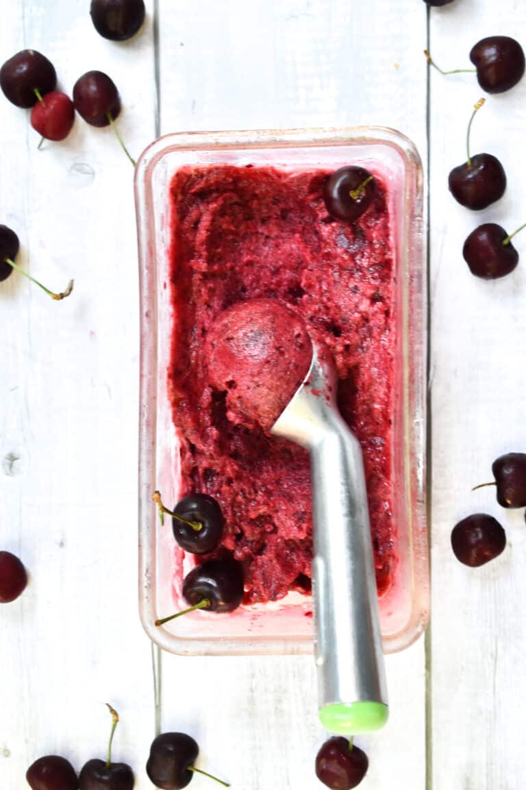 An ice cream scoop in the dairy free cherry vanilla sorbet