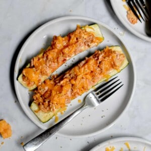 Two Buffalo Chicken Stuffed Zucchini are on a plate