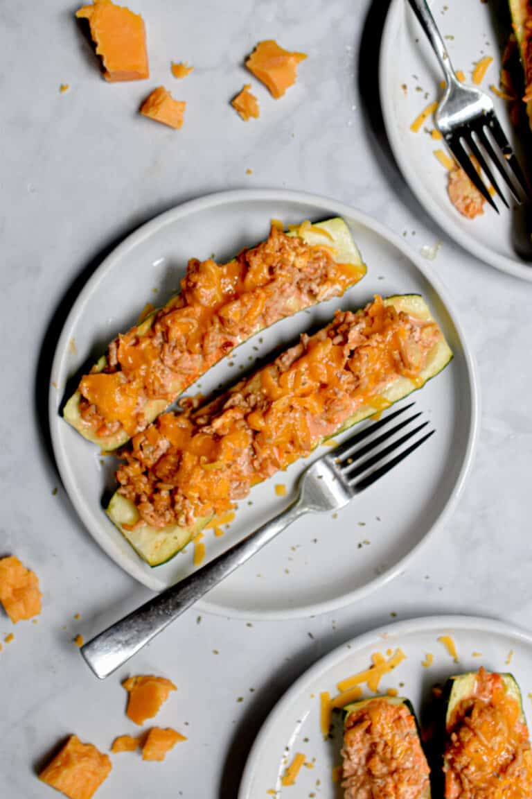 Two Buffalo Chicken Stuffed Zucchini are on a plate