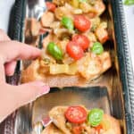 Grandma's Eggplant Caponata being taken by a hand