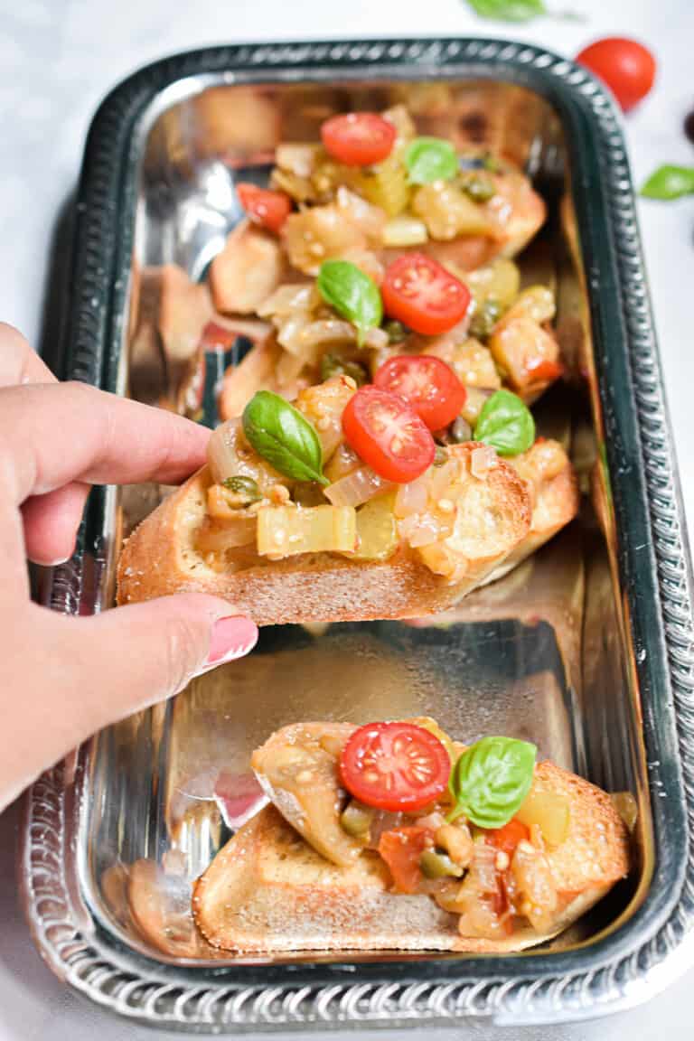 Grandma's Eggplant Caponata being taken by a hand
