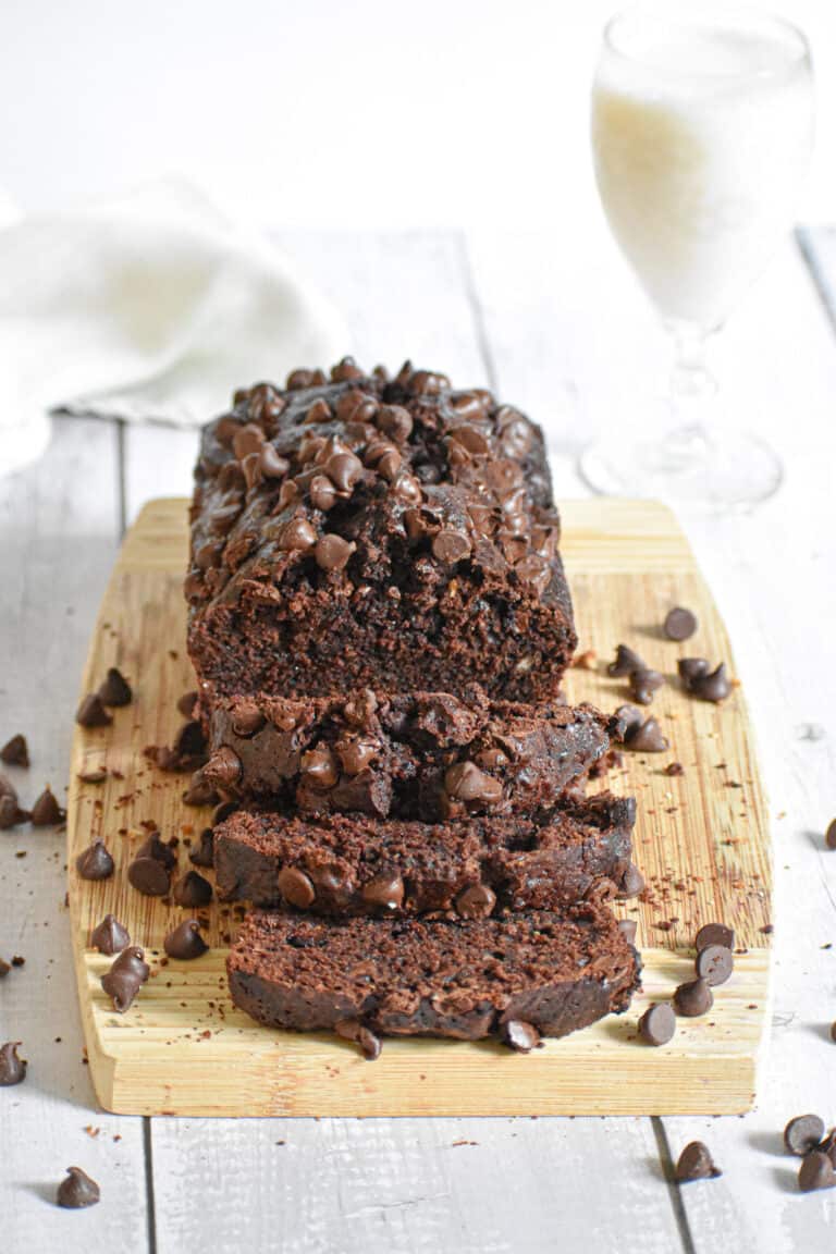 The death by chocolate zucchini bread is on a wooden cutting board