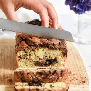 A knife is cutting into the nutella zucchini bread