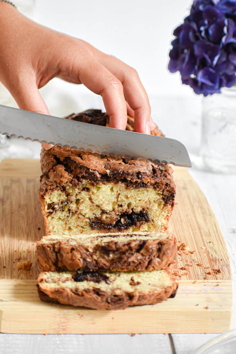 A knife is cutting into the nutella zucchini bread