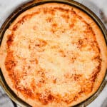 The beer pizza dough is baked with tomato sauce and cheese.