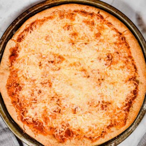The beer pizza dough is baked with tomato sauce and cheese.