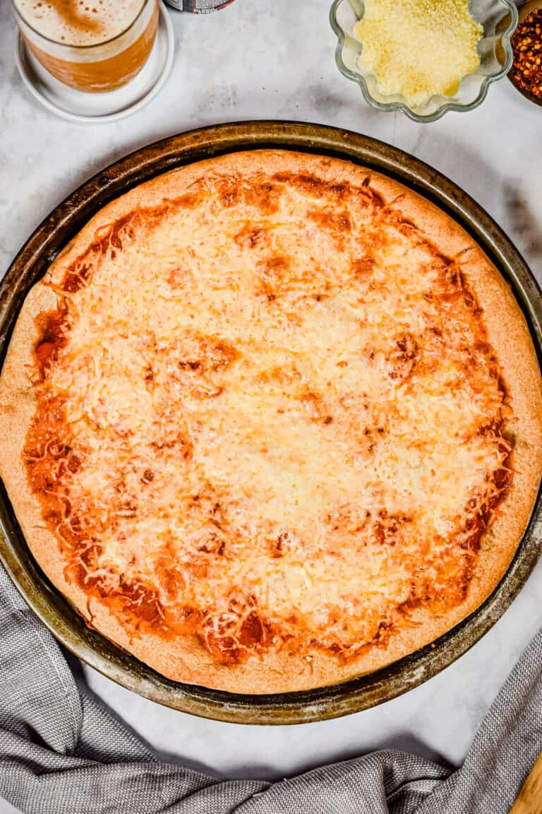 The beer pizza dough is baked with tomato sauce and cheese.