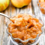 A spoonful of apple sauce is taken out of the bowl