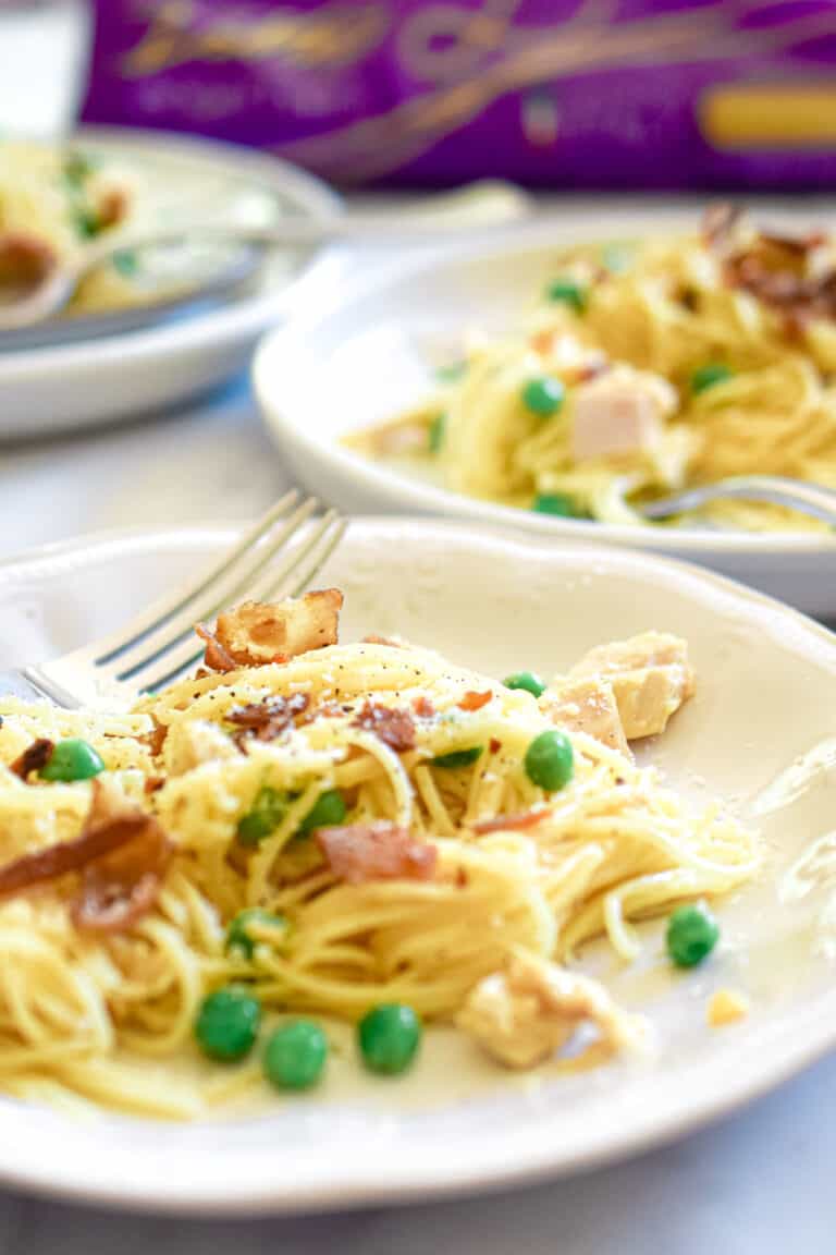 A close up of the pasta carbonara and DaVinci pasta in the background.