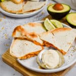 The quesadillas are served with avocado and sour cream