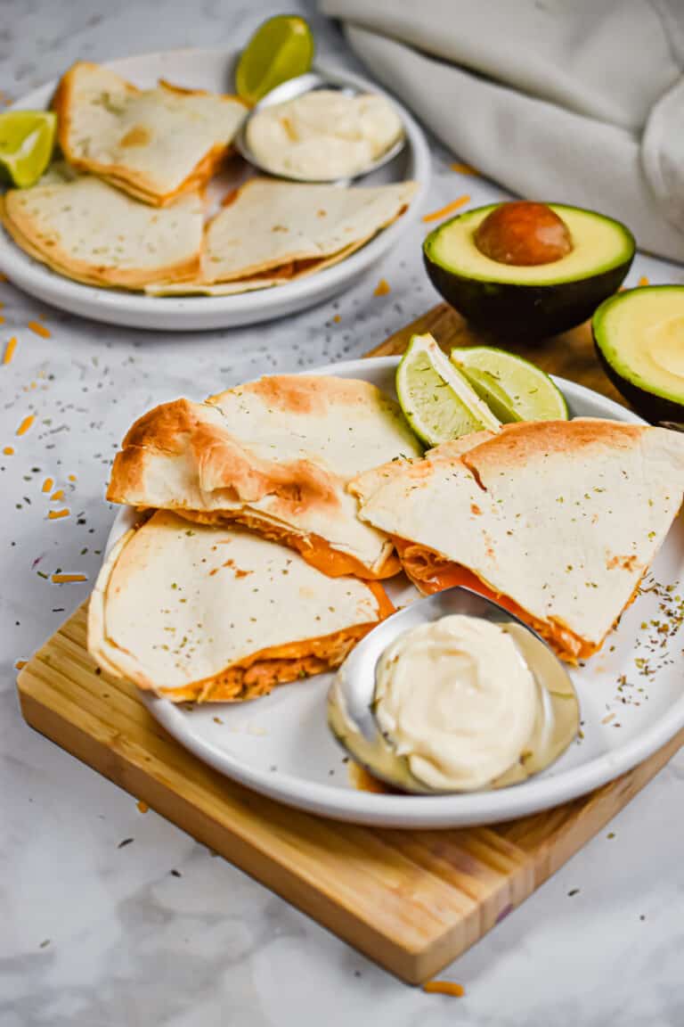 The quesadillas are served with avocado and sour cream