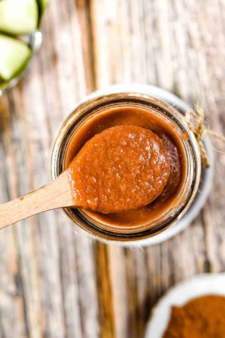 An overhead shot of a wooden spoon showing the texture of the Instant Pot Apple Butter