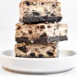 Three Oreo Cheesecake Bars are stacked