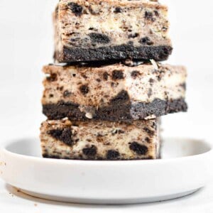 Three Oreo Cheesecake Bars are stacked