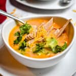 A bowl of soup with another bowl in the background