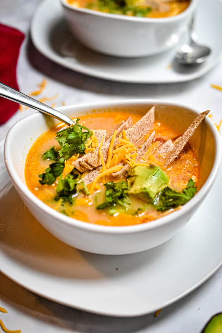 A bowl of soup with another bowl in the background