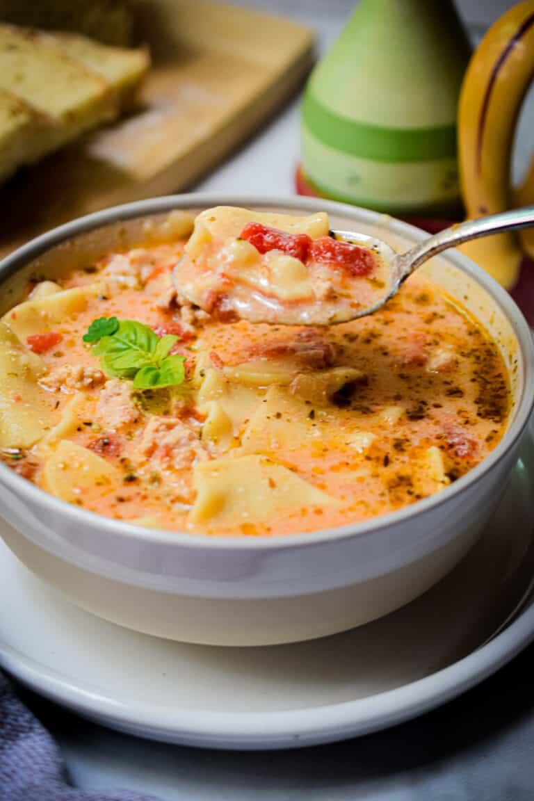 A spoonful of the lasagna soup is lifted from the bowl