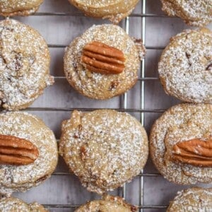 Twelve brown butter pecan cookies are on a wire rack