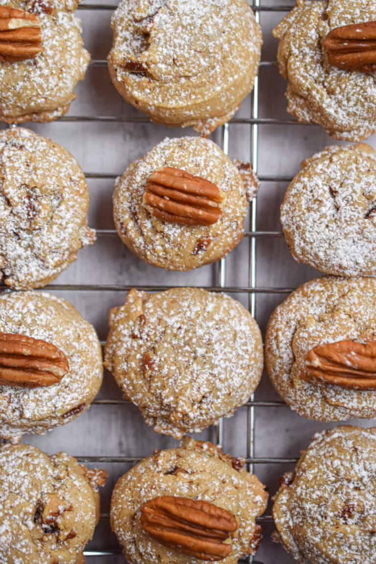 Twelve brown butter pecan cookies are on a wire rack