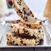 A hand is picking up one sourdough biscotti