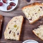 Slices of olive bread in instant pot are laid out with red and green olives