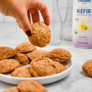 A hand is picking up the kefir snickerdoodles
