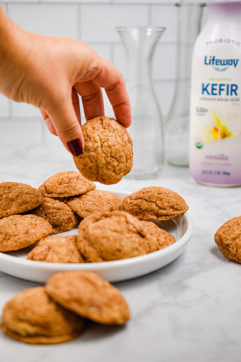A hand is picking up the kefir snickerdoodles