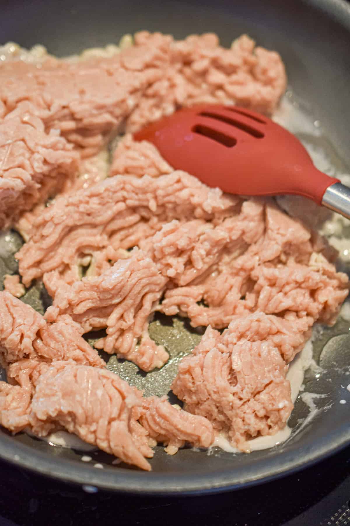 The ground chicken is being cooked in my sauté pan.