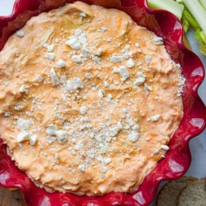 The Instant Pot Buffalo Chicken Dip is in a fluted red plate.