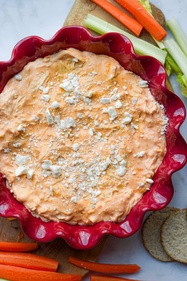 The Instant Pot Buffalo Chicken Dip is in a fluted red plate.