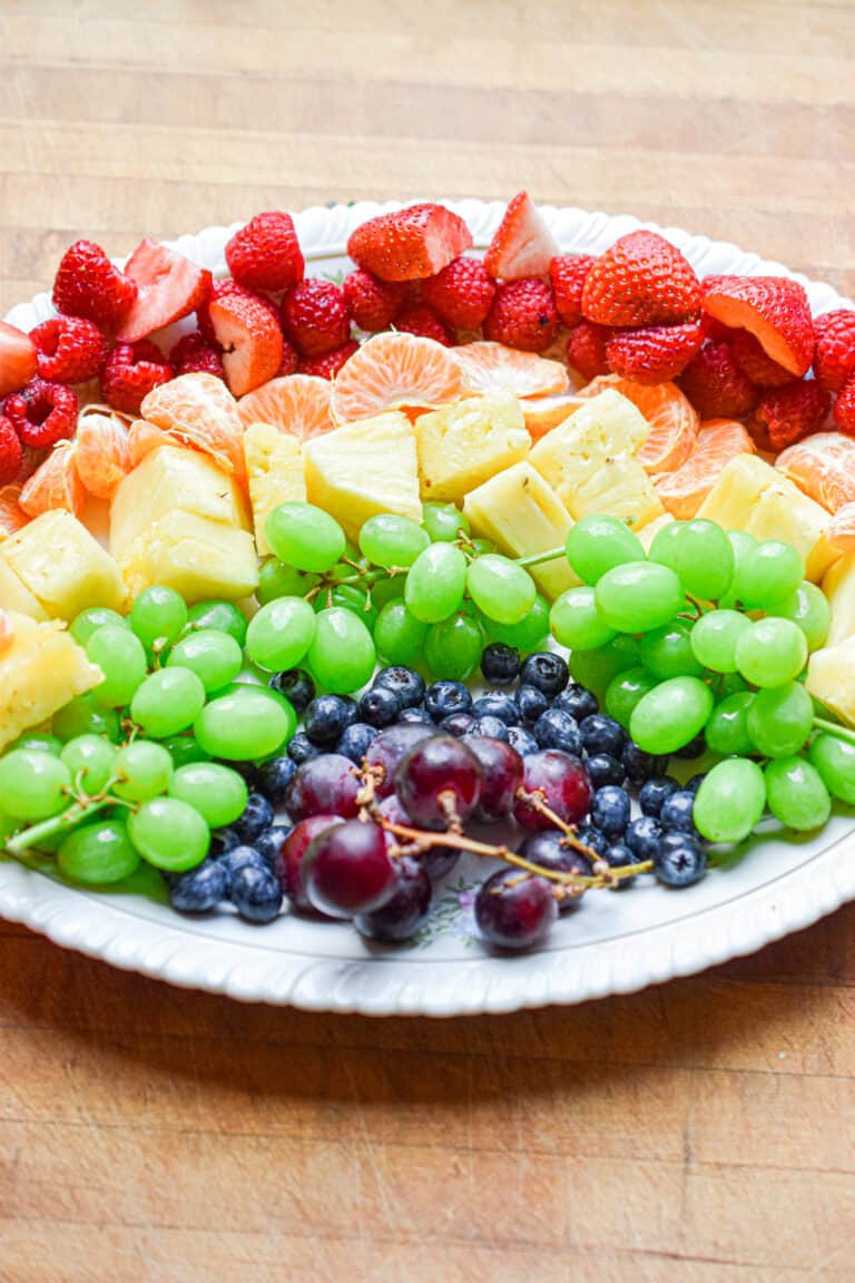 The rainbow fruit platter is done and on an oval platter.