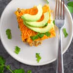A piece of the vegan breakfast strata is topped with avocado