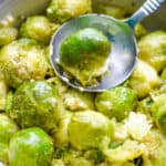 A spoon is holding an instant pot brussel sprout.