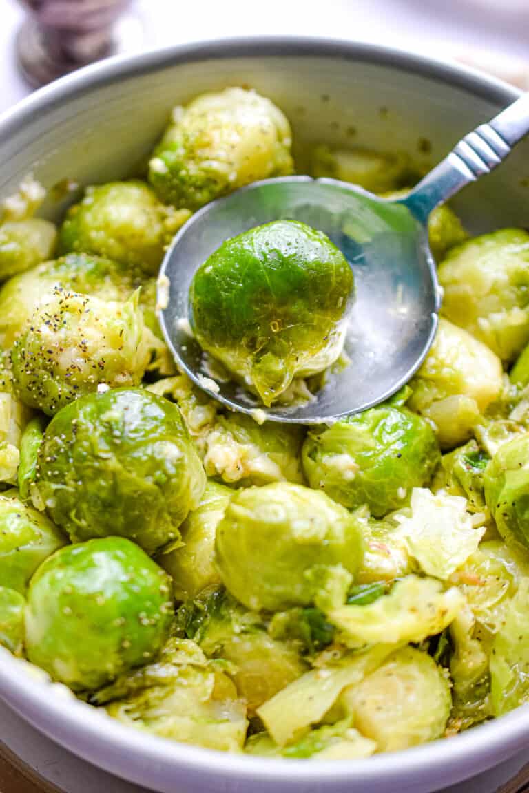A spoon is holding an instant pot brussel sprout.
