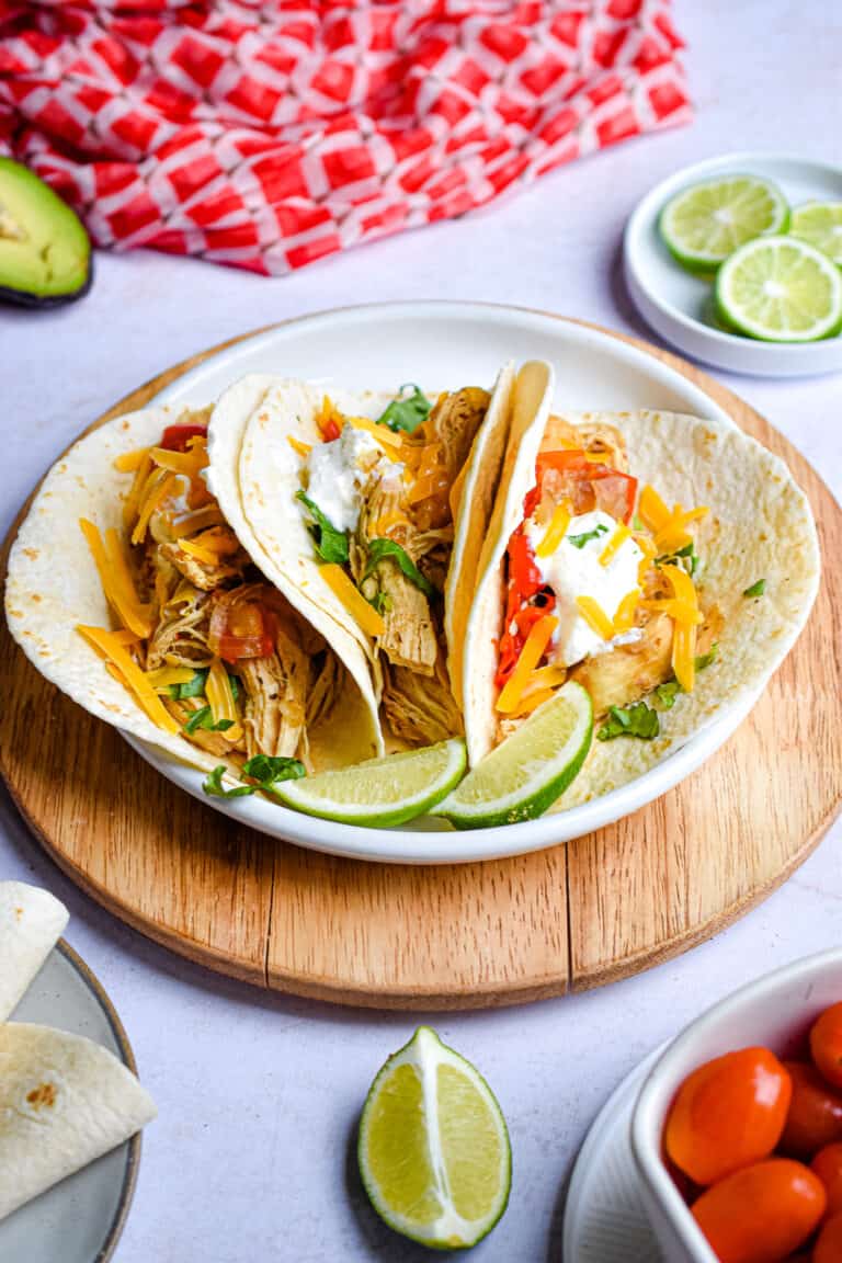 The Chicken fajitas are on a plate on a cutting board