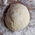 The dough is on a floured surface.