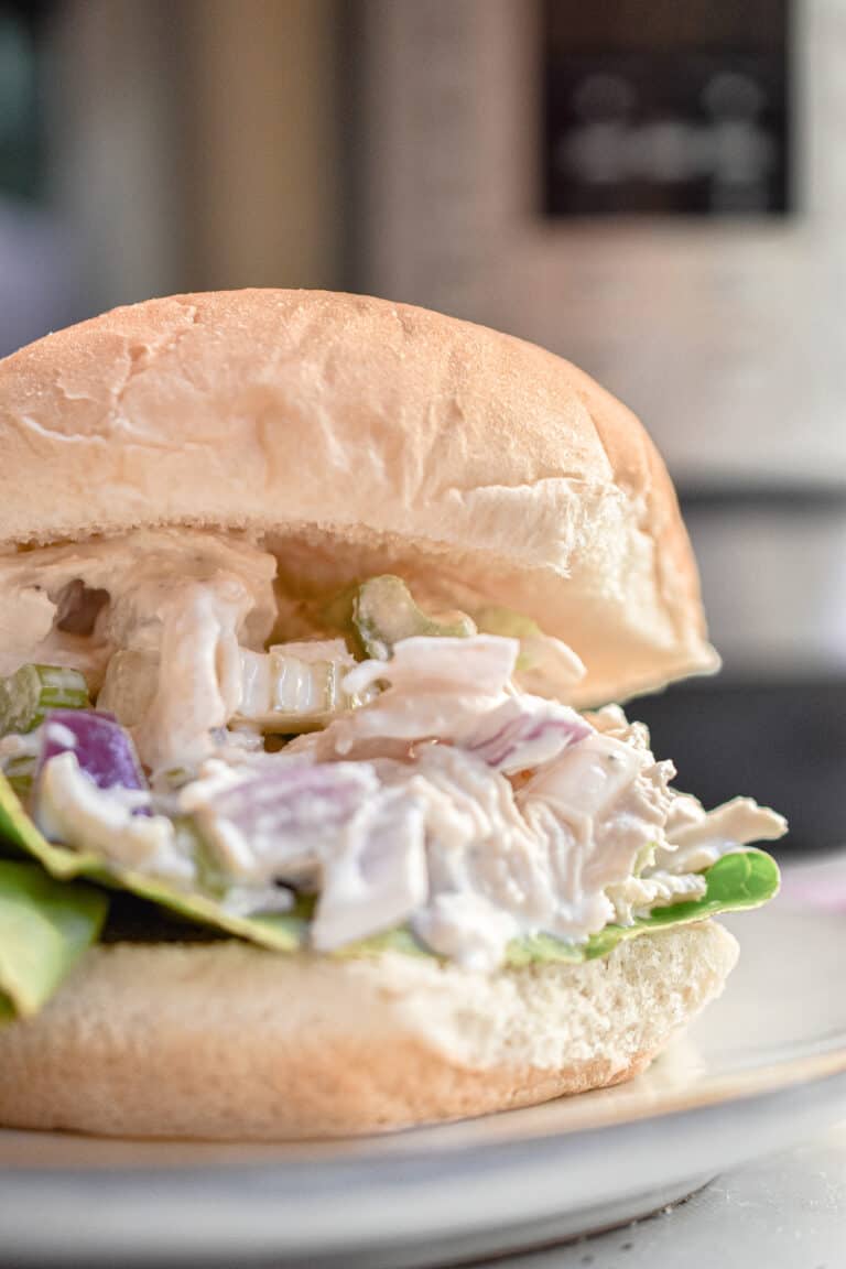 The instant pot chicken salad is on a bulky roll.