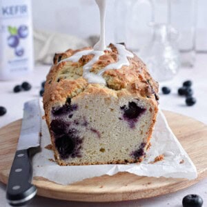 The icing is being poured onto the blueberry kefir bread.