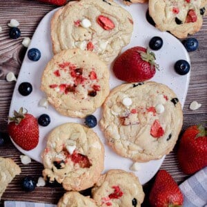 An overhead shot of red white and blue cookies on a cutting board