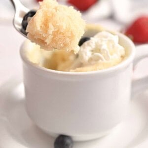 The spoon is lifting the pancake in a mug.